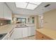 Bright kitchen featuring white cabinets, a white appliance, and a view into the living area at 2320 Terra Ceia Bay Blvd # 406, Palmetto, FL 34221