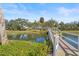 Scenic view of a pond crossed by a charming wooden bridge, surrounded by mature trees and landscaping at 2320 Terra Ceia Bay Blvd # 406, Palmetto, FL 34221