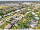 Scenic aerial view of a charming neighborhood with lush green landscaping and a community pool at 2341 Siesta Dr, Sarasota, FL 34239