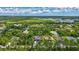 A tranquil neighborhood features homes nestled among trees, capturing an idyllic sense of suburban living at 2625 Yuma Ave, North Port, FL 34286