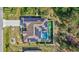Stunning aerial view of a home with a pool, solar panels, and lush landscaping at 2625 Yuma Ave, North Port, FL 34286