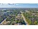 Aerial view of a tree-lined neighborhood showcasing lush greenery and blue skies at 2625 Yuma Ave, North Port, FL 34286