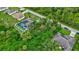 Solar panel home with screened pool surrounded by beautiful landscaping as seen from an aerial perspective at 2625 Yuma Ave, North Port, FL 34286