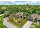 Aerial view of a charming home with a detached garage, gazebo, and beautifully landscaped yard with mature trees at 2625 Yuma Ave, North Port, FL 34286