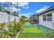 Landscaped backyard with green turf and lush plants, perfect for relaxation and outdoor activities at 2625 Yuma Ave, North Port, FL 34286