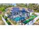 Beautiful backyard with screened-in pool, solar panels, lush landscape, and privacy fence at 2625 Yuma Ave, North Port, FL 34286