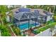 The backyard boasts a screened-in pool, lush landscaping, and solar panels on the roof at 2625 Yuma Ave, North Port, FL 34286