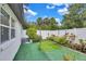 Private backyard area with artificial turf and charming landscaping, a delightful outdoor space at 2625 Yuma Ave, North Port, FL 34286