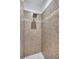 Walk-in shower with brown tilework and a showerhead at 2625 Yuma Ave, North Port, FL 34286
