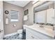 Stylish bathroom featuring a marble countertop, decorative tile floor, and updated fixtures at 2625 Yuma Ave, North Port, FL 34286
