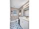 Modern bathroom showcasing patterned tile flooring, updated vanity, and chic decorative accents at 2625 Yuma Ave, North Port, FL 34286