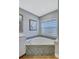 Bathroom featuring a corner jacuzzi tub, window, and tile accents at 2625 Yuma Ave, North Port, FL 34286