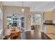 Bright dining area featuring wood floors, sliding glass doors to lanai, and modern lighting at 2625 Yuma Ave, North Port, FL 34286