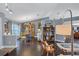 Bright dining room features hardwood floors, a wooden hutch, and a view from a large window at 2625 Yuma Ave, North Port, FL 34286