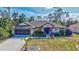 Beautiful one-story home with a well-maintained lawn, mature trees, and a spacious driveway at 2625 Yuma Ave, North Port, FL 34286