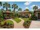 Charming cottage with a tile roof, a front yard gazebo and beautifully landscaped garden beds at 2625 Yuma Ave, North Port, FL 34286