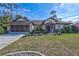 Exterior of a single story home with a front yard, driveway, and two car garage at 2625 Yuma Ave, North Port, FL 34286