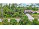Charming single-story home with a well-maintained lawn, lush tropical landscaping and a welcoming two-car garage at 2625 Yuma Ave, North Port, FL 34286