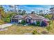 Beautifully landscaped single Gathering home with a well manicured lawn and solar panels on the roof at 2625 Yuma Ave, North Port, FL 34286