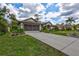 A well maintained home with a long drive and lush landscaping at 2625 Yuma Ave, North Port, FL 34286