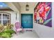 Charming front entry featuring double doors, decorative art and a pink chair at 2625 Yuma Ave, North Port, FL 34286
