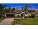 Charming single-story home with lush landscaping, a two-car garage, and a well-maintained lawn at 2625 Yuma Ave, North Port, FL 34286