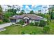 Charming single-story home featuring lush landscaping, solar panels, and a screened garage at 2625 Yuma Ave, North Port, FL 34286