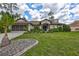 Charming single-story home featuring a well-manicured lawn and beautifully landscaped flowerbeds at 2625 Yuma Ave, North Port, FL 34286