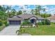 Beautiful single-story house with a well-manicured lawn and a screened garage at 2625 Yuma Ave, North Port, FL 34286