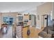 Bright kitchen has stainless appliances, granite counters, breakfast bar with seating, and flows into the dining area at 2625 Yuma Ave, North Port, FL 34286