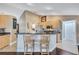 Stylish kitchen with breakfast bar, stainless steel appliances, open to other living and dining areas at 2625 Yuma Ave, North Port, FL 34286