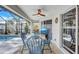 A covered lanai features a dining table and television with an outdoor view at 2625 Yuma Ave, North Port, FL 34286
