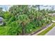 Lush, tropical landscaping surrounds this home, offering beauty and privacy, creating a serene outdoor environment at 2625 Yuma Ave, North Port, FL 34286