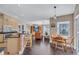 Open-concept living area combines the kitchen, breakfast nook, and living room with hardwood floors at 2625 Yuma Ave, North Port, FL 34286