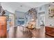 Bright living room with hardwood floors, a white sofa and access to the outdoor pool at 2625 Yuma Ave, North Port, FL 34286