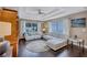 Bright living room with hardwood floors, coffered ceiling, abundant natural light, and comfortable sofa at 2625 Yuma Ave, North Port, FL 34286