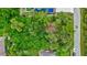 Aerial view of a vacant lot surrounded by lush greenery, offering a prime location for building a dream home at 2625 Yuma Ave, North Port, FL 34286