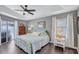 Cozy bedroom with a comfortable queen bed, ceiling fan, and sliding glass door at 2625 Yuma Ave, North Port, FL 34286