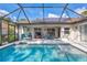 Swimming pool with an outdoor screened in lanai that features a dining space at 2625 Yuma Ave, North Port, FL 34286