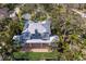 Stunning aerial view of the beautiful home with a metal roof, lush landscaping, and an inviting backyard at 2828 Riverview Blvd, Bradenton, FL 34205