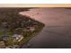 Waterfront property featuring manicured lawn and private docks and boat slips at sunset at 2828 Riverview Blvd, Bradenton, FL 34205