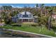 Impressive estate home surrounded by palm trees and lush landscaping with waterfront views at 2828 Riverview Blvd, Bradenton, FL 34205