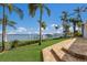 Brick path leading from grassy lawn to scenic bay with boat dock beyond at 2828 Riverview Blvd, Bradenton, FL 34205