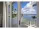 Beautiful waterfront balcony view with blue skies, clear water, and swaying palm trees at 2828 Riverview Blvd, Bradenton, FL 34205
