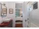 Modern bathroom featuring a vessel sink, shower over tub with white subway tile, and hardwood floors at 2828 Riverview Blvd, Bradenton, FL 34205