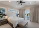 Bedroom featuring a vaulted ceiling, balcony access, and serene decor at 2828 Riverview Blvd, Bradenton, FL 34205