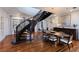 Elegant dining room features a unique spiral staircase and a modern light fixture above the dining table at 2828 Riverview Blvd, Bradenton, FL 34205