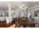 Open-concept dining room with wood floors, chandelier, and sliding doors to the outdoor area at 2828 Riverview Blvd, Bradenton, FL 34205