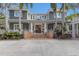 Charming home featuring a welcoming front entrance with brick steps and a meticulously landscaped yard with palm trees at 2828 Riverview Blvd, Bradenton, FL 34205