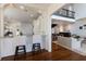Bright and airy kitchen with a breakfast bar and hardwood floors leading to the living space at 2828 Riverview Blvd, Bradenton, FL 34205